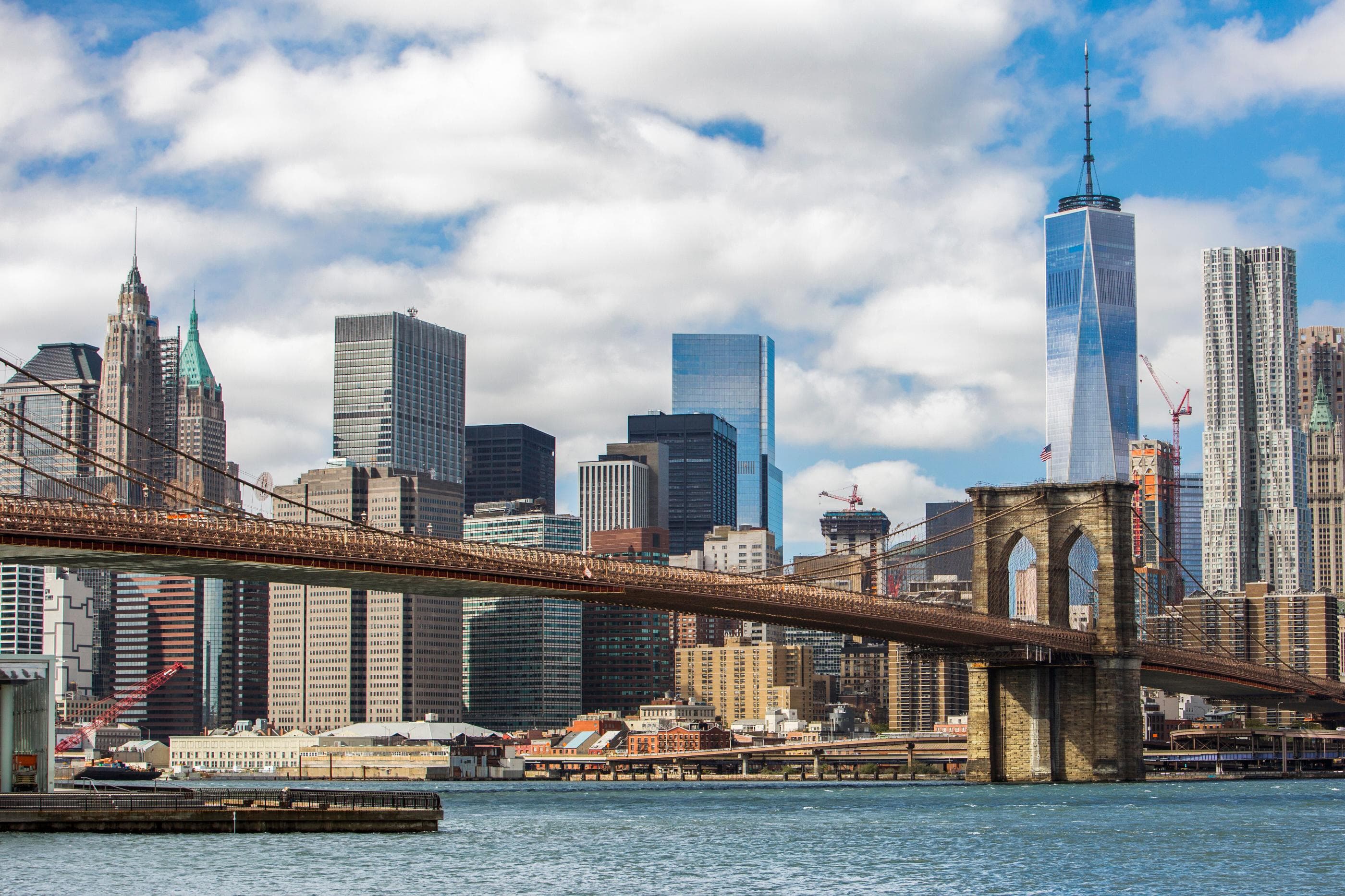 View of the New York City skyline with the Brooklyn Bridge in the foreground